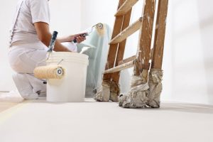 A painter working next to a ladder.