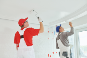 two painters inspecting a ceiling